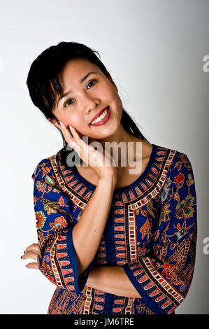 Beautiful Singapore girl in traditional dress Stock Photo