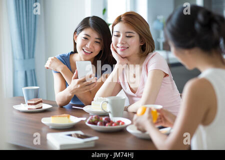 Best female friends having afternoon tea at home Stock Photo