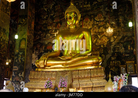 Sitting golden Buddha statue on main altar at Wat Suthat Thepwararam, a Buddhist temple in Bangkok, Thailand. Stock Photo