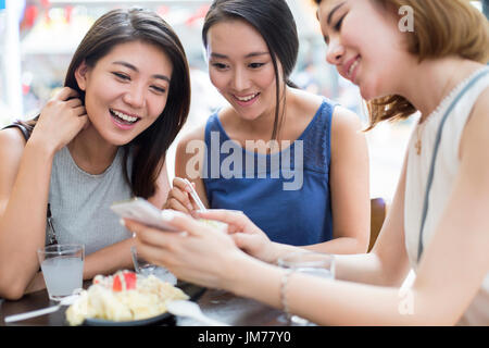 Best female friends sitting at sidewalk cafÃ© Stock Photo
