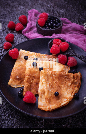 Pancakes with blueberries and raspberries. Selective focus Stock Photo