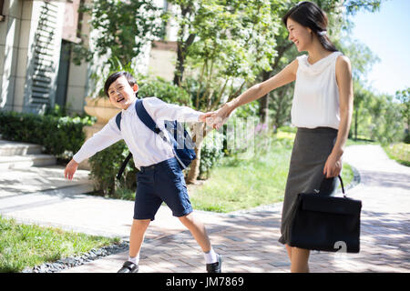 Chinese mother taking her child to school in the morning Stock Photo