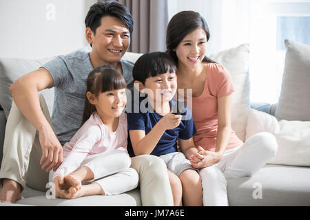 Happy young Chinese family watching TV Stock Photo - Alamy