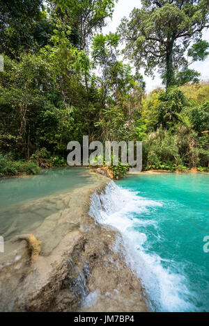 Vertical picture of small waterfall at Kuang Si Falls in Laos.