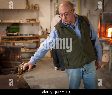 The glassblowers work in their workshop on Murano island, Venice, Italy Stock Photo