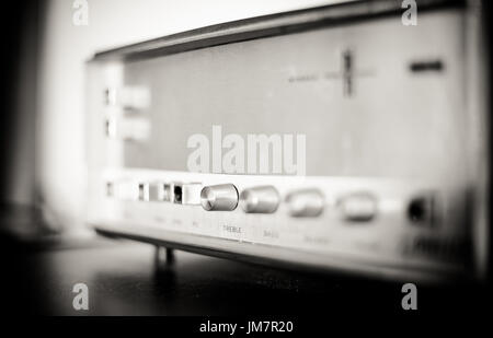 Vintage radio tuner home interior, black and white and selective focus on knobs concept of past time Stock Photo