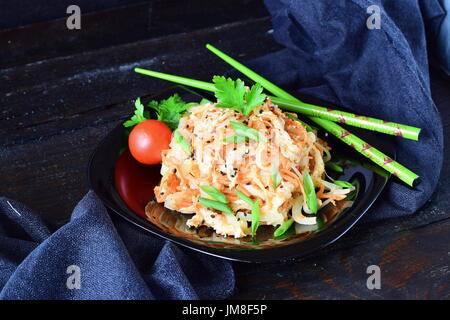 Korean traditional kitchen. Raw marinated chicken in soy sauce, spices, onions and carrots on a black plate on a dark background. Healthy food. Healthy eating concept. Stock Photo
