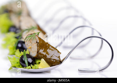 Stuffed grape leaves with black olives on appetizer spoons Stock Photo