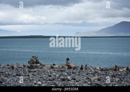 Rock piles left by tourists on a stony beach, Reykjavik, Iceland. Stock Photo