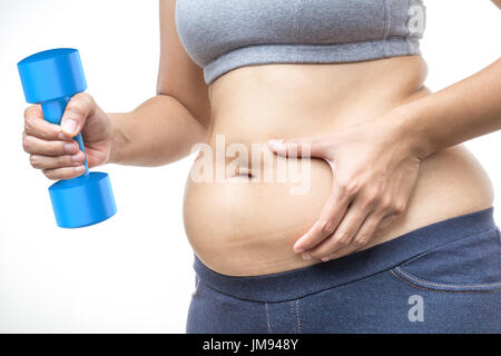 overweight woman hand holding fat belly and dumbbell Stock Photo