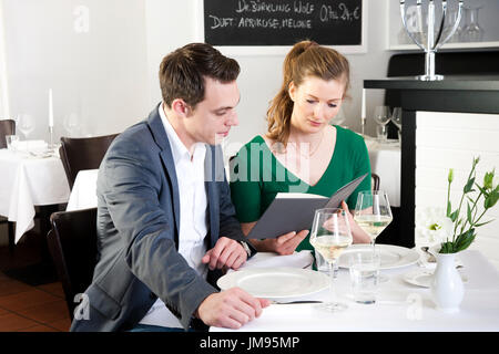 Couple is reading the menu together in a restaurant