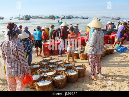 Mui Ne, Vietnam - June 27, 2017: Crowded scene of daily early morning fish market on beach Stock Photo