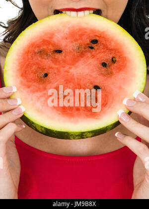 Young Woman Holding a Fresh Ripe Juicy Watermelon Isolated Against A White Background Stock Photo