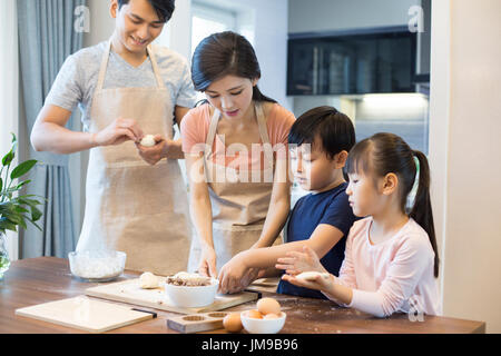 Happy young Chinese family baking together Stock Photo