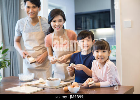 Happy young Chinese family baking together Stock Photo