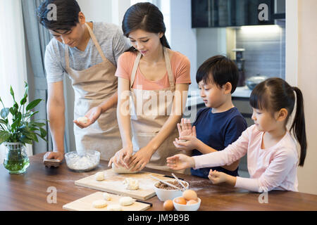 Happy young Chinese family baking together Stock Photo