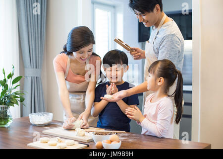 Happy young Chinese family baking together Stock Photo