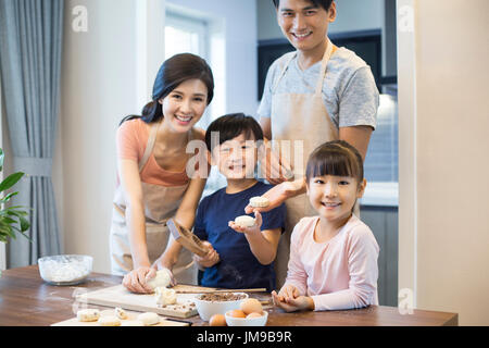 Happy young Chinese family baking together Stock Photo