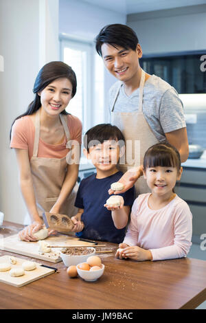 Happy young Chinese family baking together Stock Photo