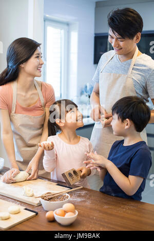 Happy young Chinese family baking together Stock Photo