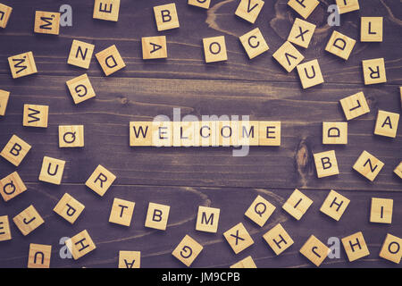 Welcome word wood block on table for business concept. Stock Photo
