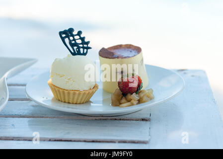 Delicious desserts at beach table Stock Photo