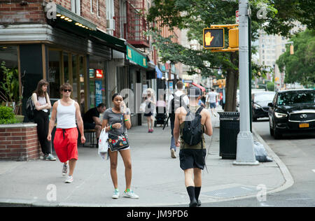 New York City Manhattan Sidewalk On 6th Avenue And Woman Carrying