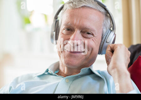 Senior Man Listening To Music On Wireless Headphones Stock Photo