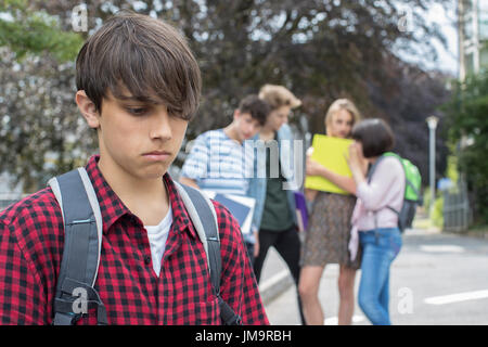 Unhappy Girl Being Gossiped About By School Friends Stock Photo - Alamy