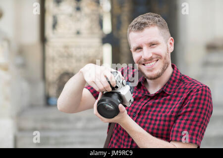 Portrait Of Male Photographer Working In Street Stock Photo