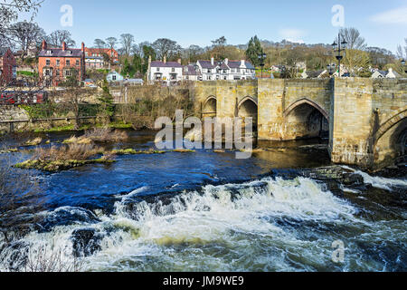 River Dee flowing through the centre of Llangollen showing the Dee Bridge a scheduled ancient monument Denbighshire Wales UK March 3298 Stock Photo