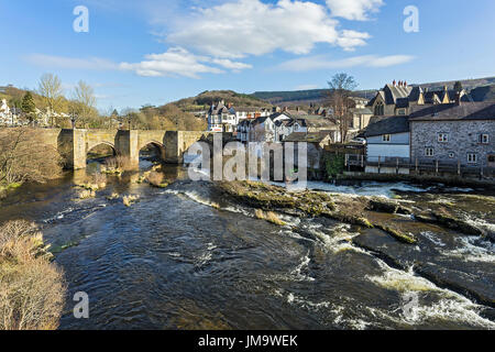 River Dee flowing through the centre of Llangollen showing the Dee Bridge a scheduled ancient monument Denbighshire Wales UK March 3369 Stock Photo