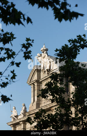 Top section of the Puerta de Alcalá in Madrid, Spain viewed through trees Stock Photo