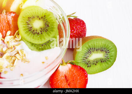 Yogurt with exotic fruits on a white background in the studio. The concept of a healthy diet. Stock Photo