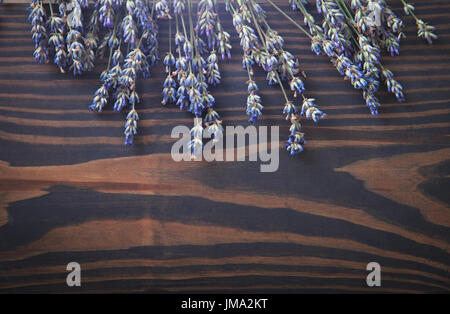 Bunch of dried lavender on wooden background. Stock Photo