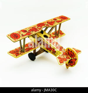 Toy airplane painted in khokhloma style isolated on white background Stock Photo