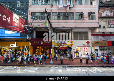 HONG KONG - OCTOBER 22, 2016: Causeway Bay street in Hong Kong, Central District. Pedestrians on the sidewalk among the various shops. Stock Photo