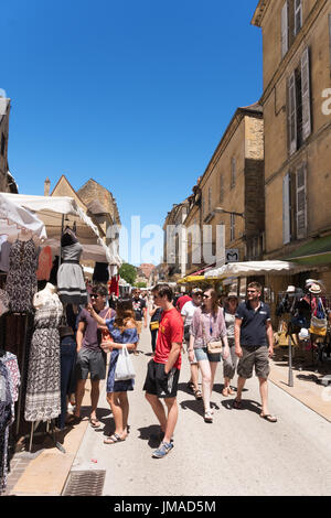 Young people walking through the open air street market in Sarlat, France, Europe Stock Photo