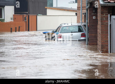 Silsted, Germany. 26th July, 2017. Cars stand in the high water in Silsted, Germany, 26 July 2017. The county Anhalt-Bitterfeld which already had do face several heavy floods sent emergency aid into the Harz region on Wednesday. Photo: Bernd März/dpa-Zentralbild/dpa/Alamy Live News Stock Photo