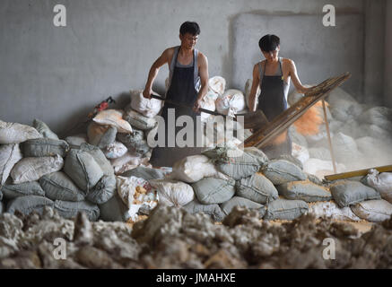 (170726) -- JIANYANG, July 26, 2017 (Xinhua) -- Lu Jinxi(L), a Jian ware porcelain craftsman, works with a young learner in a workshop in Jianyang District of Nanping City, southeast China's Fujian Province, July 25, 2017. The jian ware porcelain, flourished in Song Dynasty (960-1279), famous for its golden black glaze with streaks of 'hare's fur', is revived in recent decades after 600 years of disappearance of the knowhow of its manufacture. Lu Jinxi, 45, is one of the first craftsmen who rediscovered the long-lost art of the making of the heritage crafts.  (Xinhua/Song Weiwei) (clq)(zt) Stock Photo