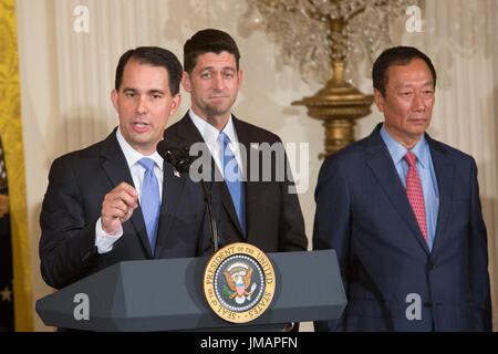 Governor Scott Walker (Republican of Wisconsin) makes remarks during the announcement of the creation of a Foxconn Factory to be built in Wisconsin to build LCD flat screen monitors at The White House in Washington, DC, July 26, 2017. With Walker is Speaker of The US House Paul Ryan (Republican of Wisconsin), center, and Foxconn CEO Terry Gou, right. Credit: Chris Kleponis/CNP /MediaPunch Stock Photo