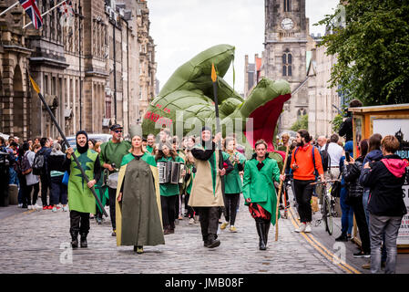 Edinburgh, UK. 27th July, 2017. A scene from 'The Dragon of Profit & Ownership', the opening performance of the 2017 Edinburgh Art Festival by Zöe Walker & Neil Bromwich. A giant inflatable dragon was taken from Trinity Apse along the Royal Mile and then slain in front of St Giles Cathedral. Credit: Andy Catlin/Alamy Live News Stock Photo