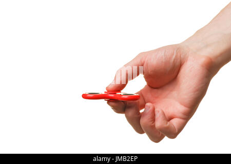 Male hand holding a red fidget spinner isolated on white background Stock Photo