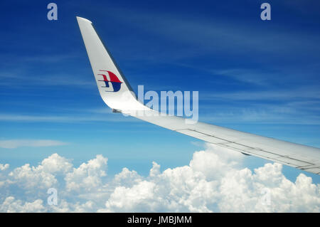 KUALA LUMPUR, MALAYSIA - MAY 09, 2015: Malaysia Airlines airplane wing with MAS logo on the sky. Malaysia Airlines behad is the flag carrier of Malays Stock Photo