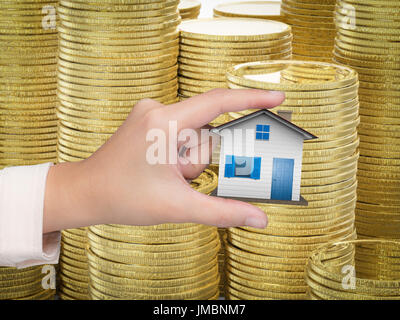 ownership concept with hand holding house model Stock Photo - Alamy