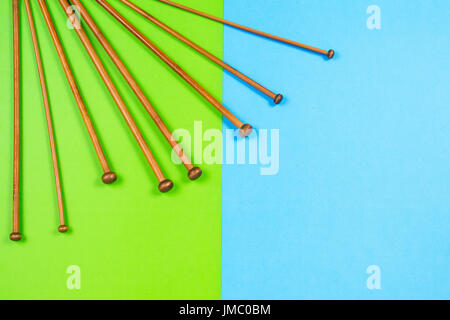 Variety of bamboo knitting needles in different sizes on colorful background Stock Photo