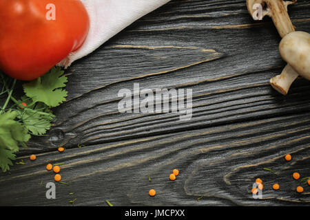 black wooden background. Blackboard. Grunge texture. Green and groats and white Linen cloth from above. Copy space for text and design. Top view wood for Food. Stock Photo
