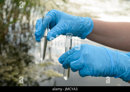 Taking a water test for analysis from a reservoir Stock Photo