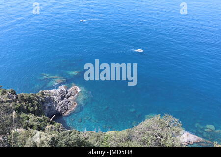 Landscape view of the cliffside fading into the sea seen while on a hike between towns in Cinque Terre, Italy Stock Photo