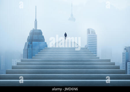 Ambitions concept with businessman climbing stairs Stock Photo